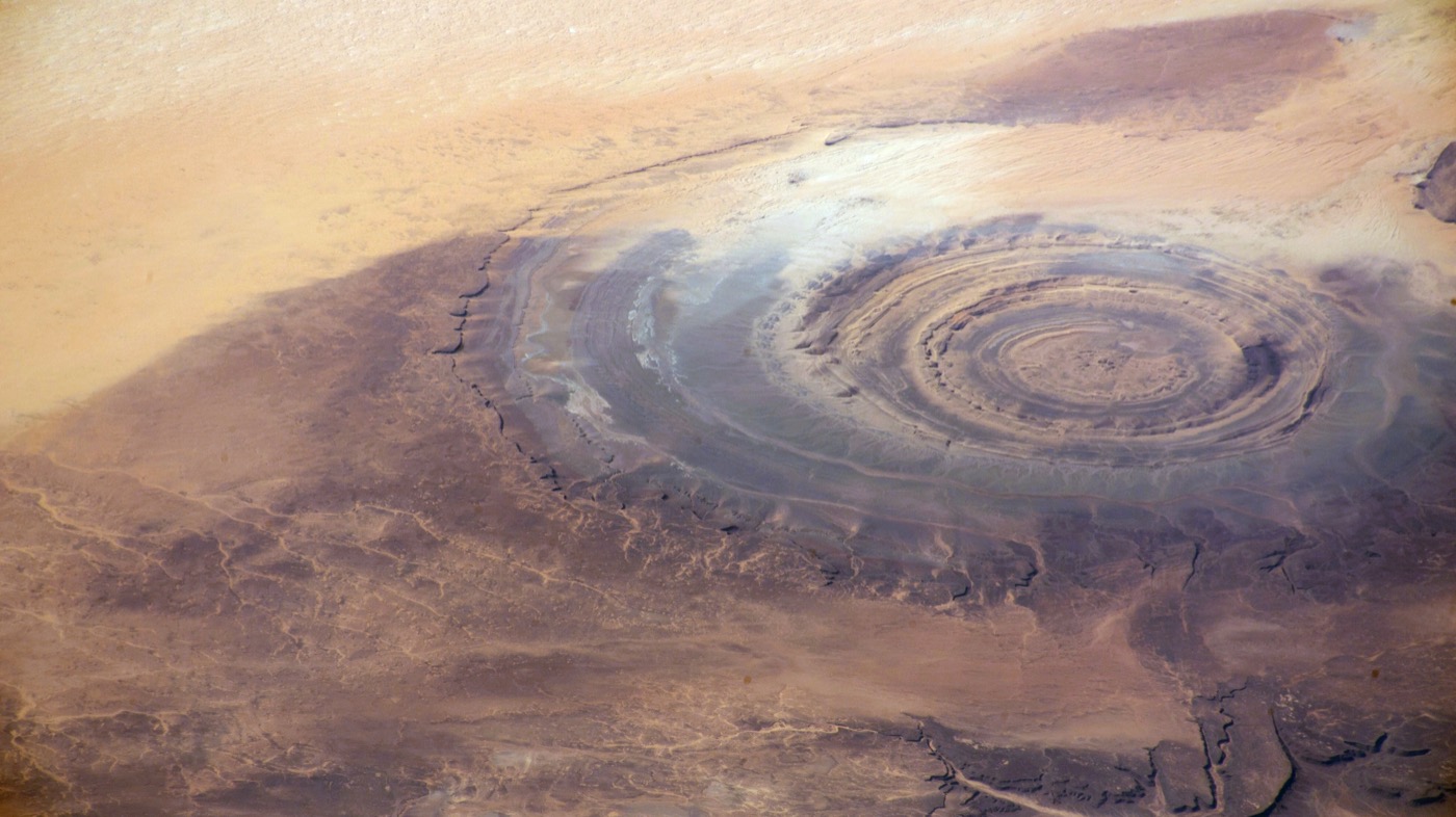 NASA ISS astronaut photograph of the Richat Structure in Mauritania — concentric rings of eroded rock in the Sahara desert.